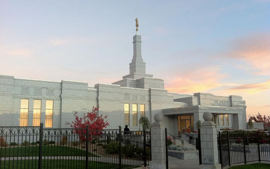 Exterior view of the Reno Nevada Temple and spire at sunset.