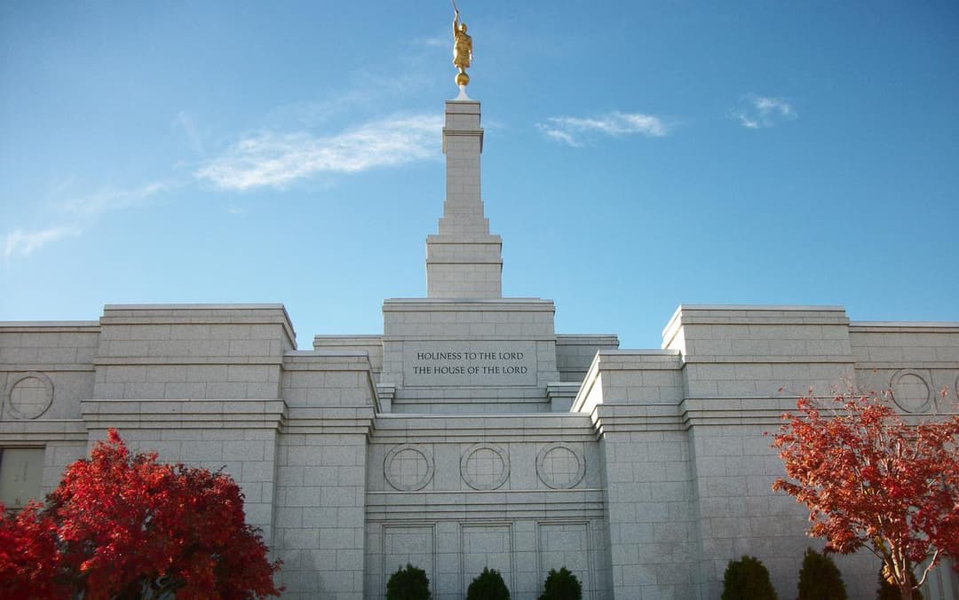 Symmetrical front view of the Reno Nevada Temple framed by autumn foliage.