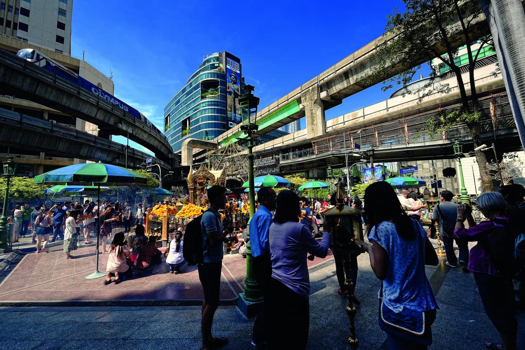 Wide-angle view of worshippers at the bustling open-air shrine.