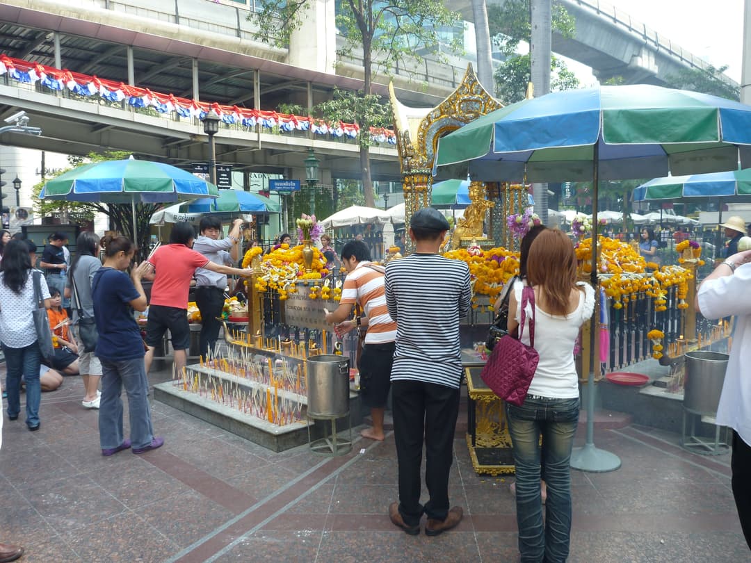 Devotees offering prayers and incense at the Shrine of Phra Phrom