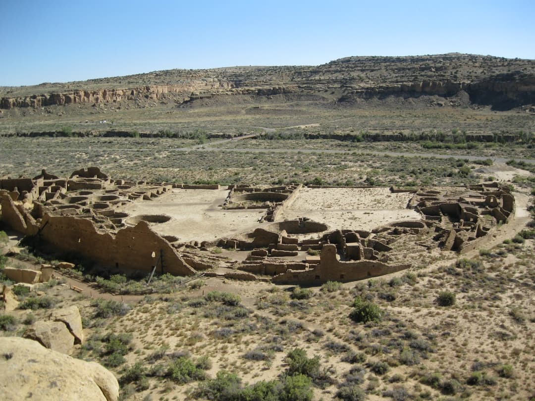 High-angle view of the D-shaped Pueblo Bonito ruins in Chaco Canyon.