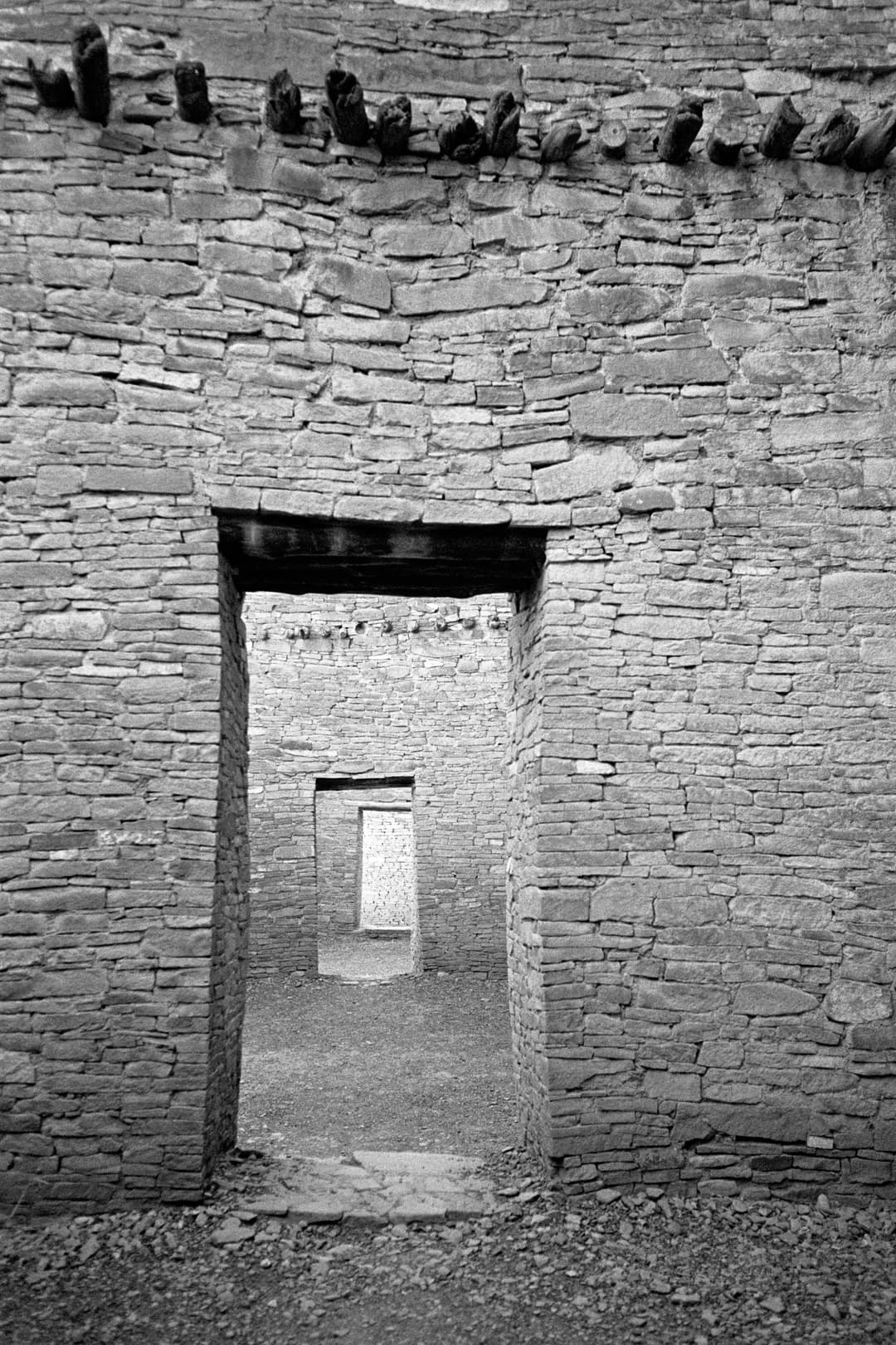 Interior view through aligned sandstone doorways at Pueblo Bonito.