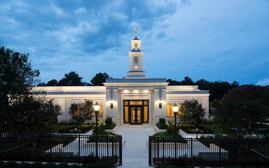 Front facade and spire of the Raleigh North Carolina Temple at twilight.