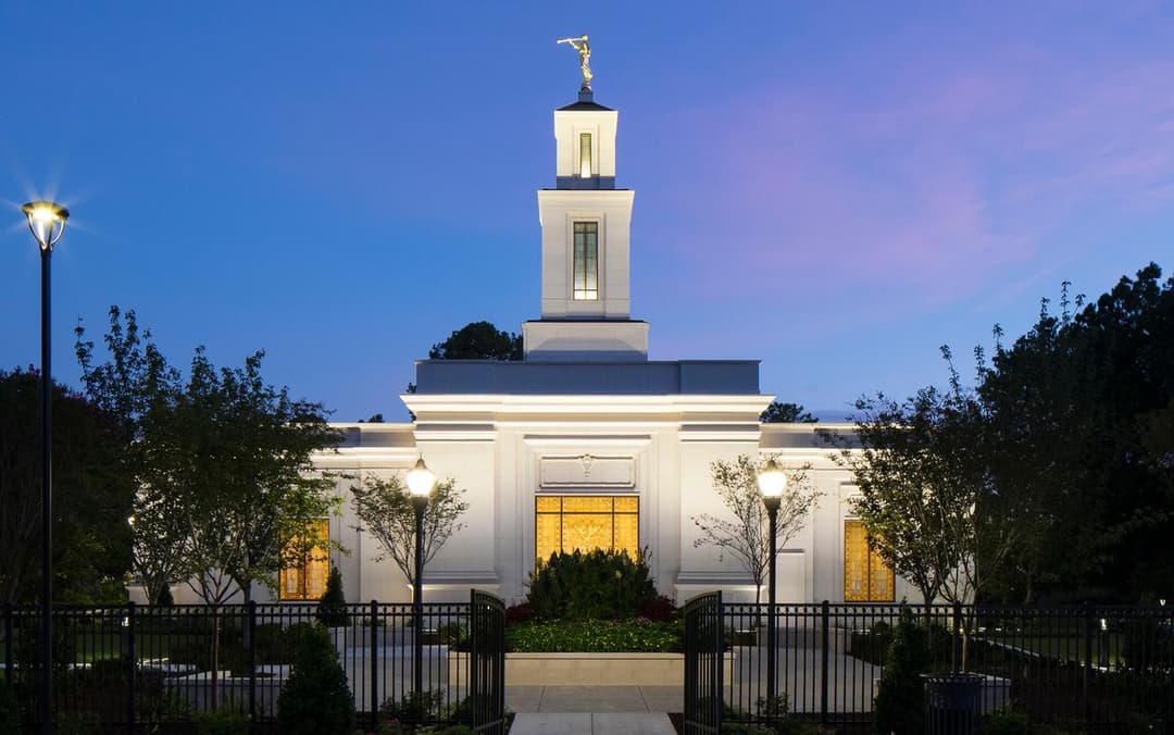 Front view of the Raleigh North Carolina Temple illuminated at twilight.