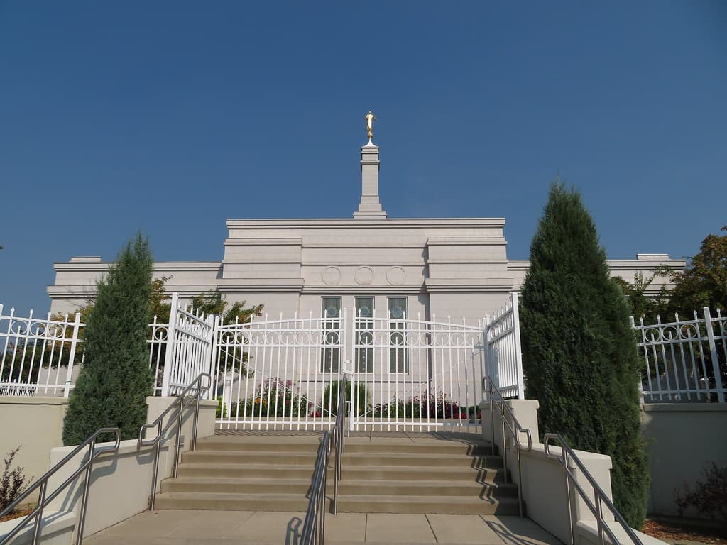 A peaceful evening view of the temple illuminated by soft exterior lighting.