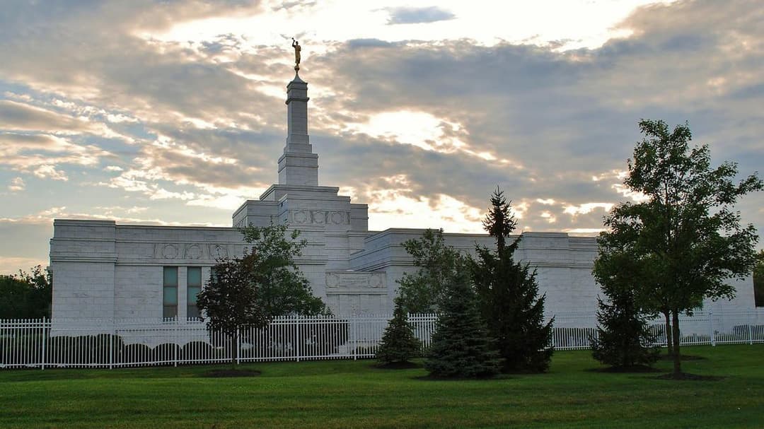 Wide-angle exterior of the Columbus Ohio Temple under a cloudy sunset sky.