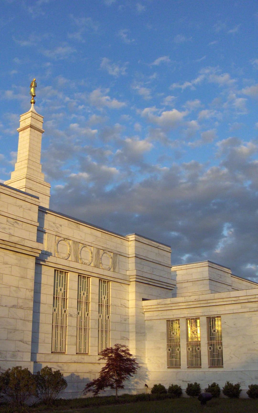 Low-angle view of the Columbus Ohio Temple facade at golden hour.