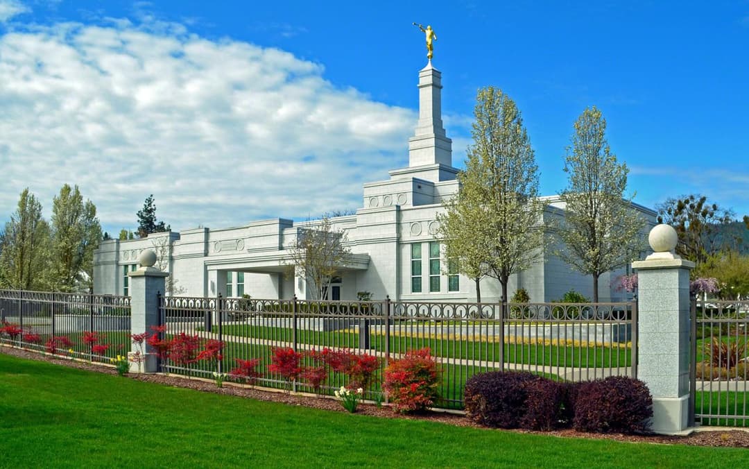 Medford Oregon Temple exterior, spire with Angel Moroni, and spring gardens.