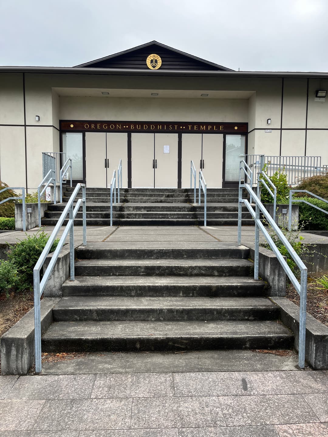 Symmetrical front entrance and concrete steps of the Oregon Buddhist Temple.
