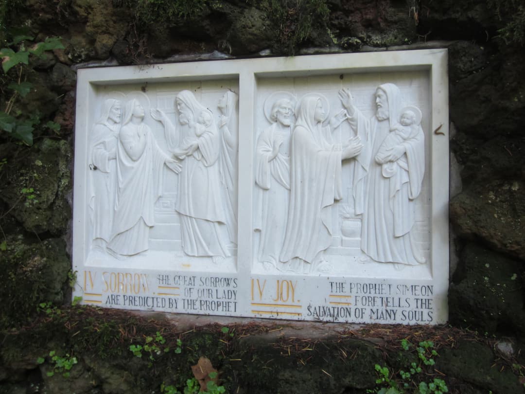 Carved stone relief depicting the Fourth Sorrow and Joy of Mary.