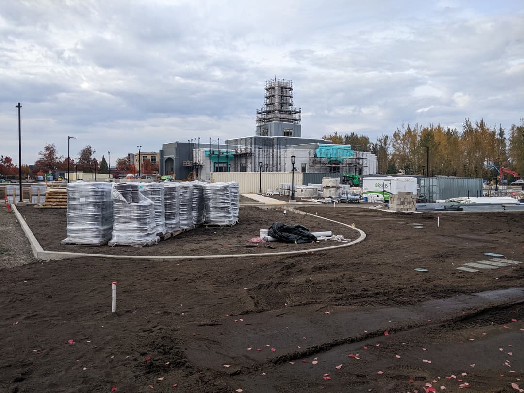 Exterior construction and grounds work with scaffolding on the tower.