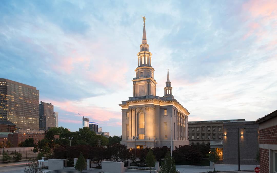 Exterior view of the illuminated Philadelphia Pennsylvania Temple at twilight.