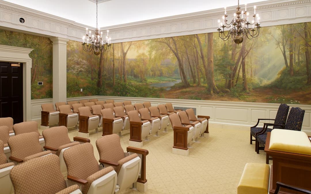 Instruction room interior featuring a scenic forest mural and seating.