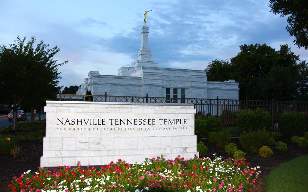 Nashville Tennessee Temple entrance sign and spire at twilight.