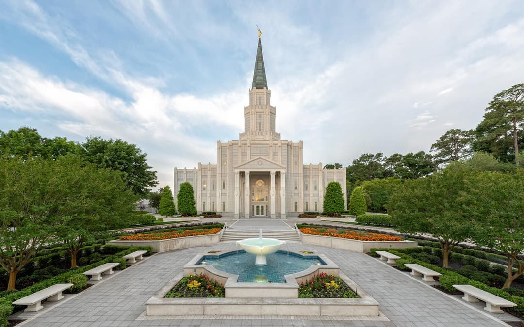 Front exterior view of the Houston Texas Temple with fountain and gardens.