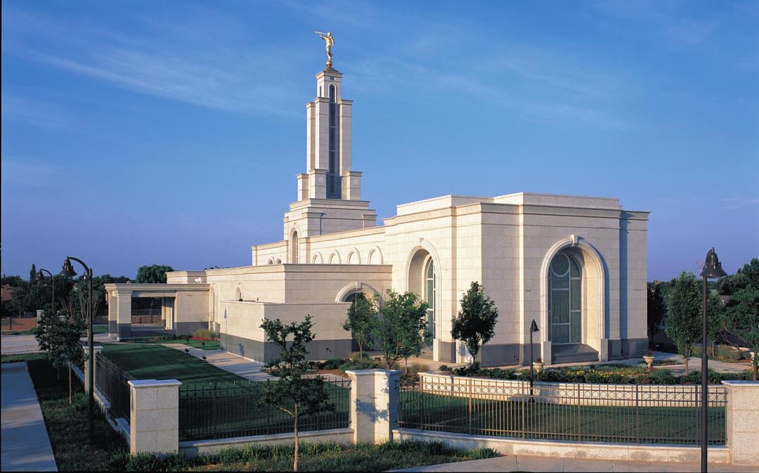 Lubbock Texas Temple exterior with Angel Moroni statue in morning light.