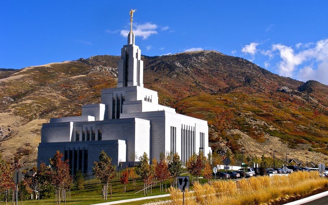 Draper Utah Temple exterior, Angel Moroni, autumn mountains, daytime.