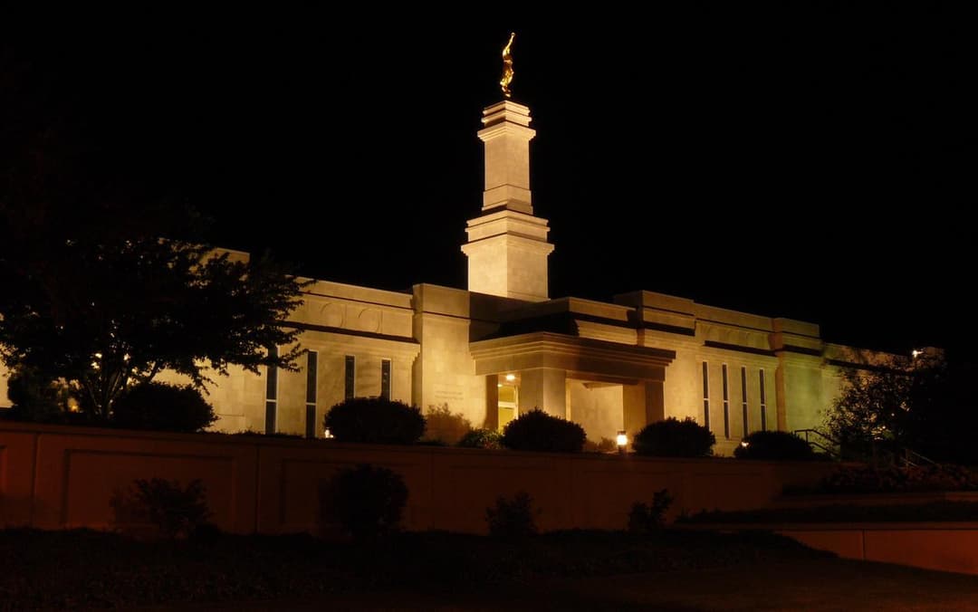 Night view of the illuminated Monticello Utah Temple and spire.