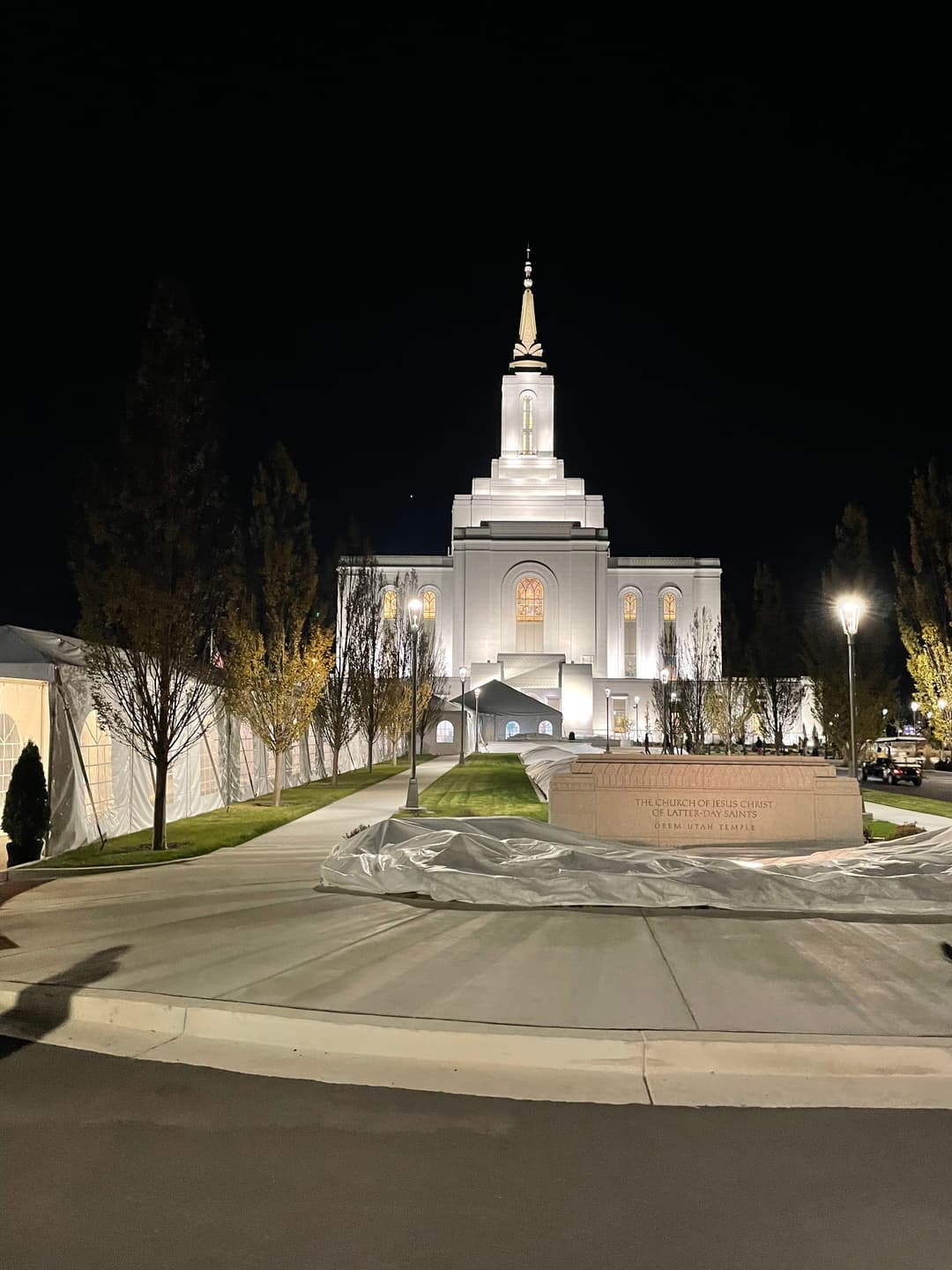 Night view of the illuminated Orem Utah Temple from the front entrance grounds.