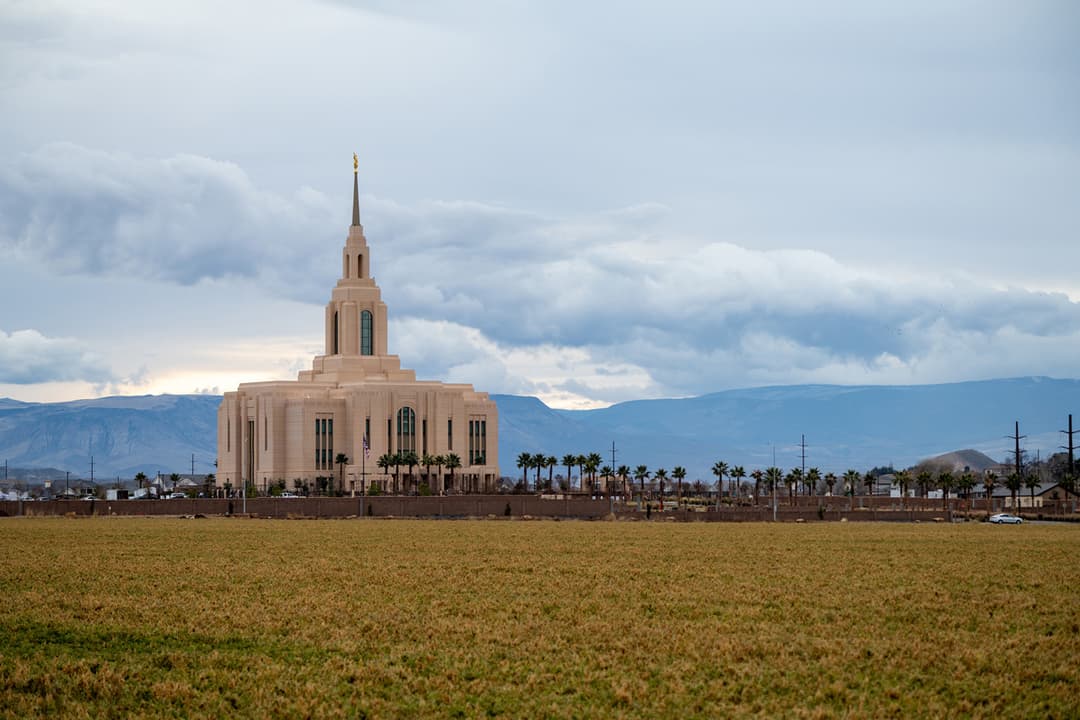 Wide exterior view of the Red Cliffs Utah Temple across an open field.