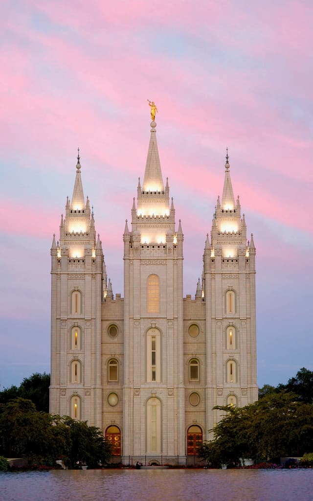 The east towers of the Salt Lake Temple reflected in water at dusk