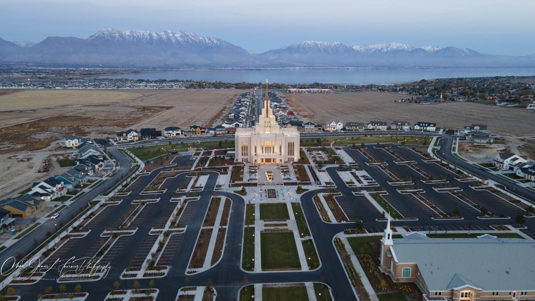 Wide aerial view of the Saratoga Springs Utah Temple at twilight.