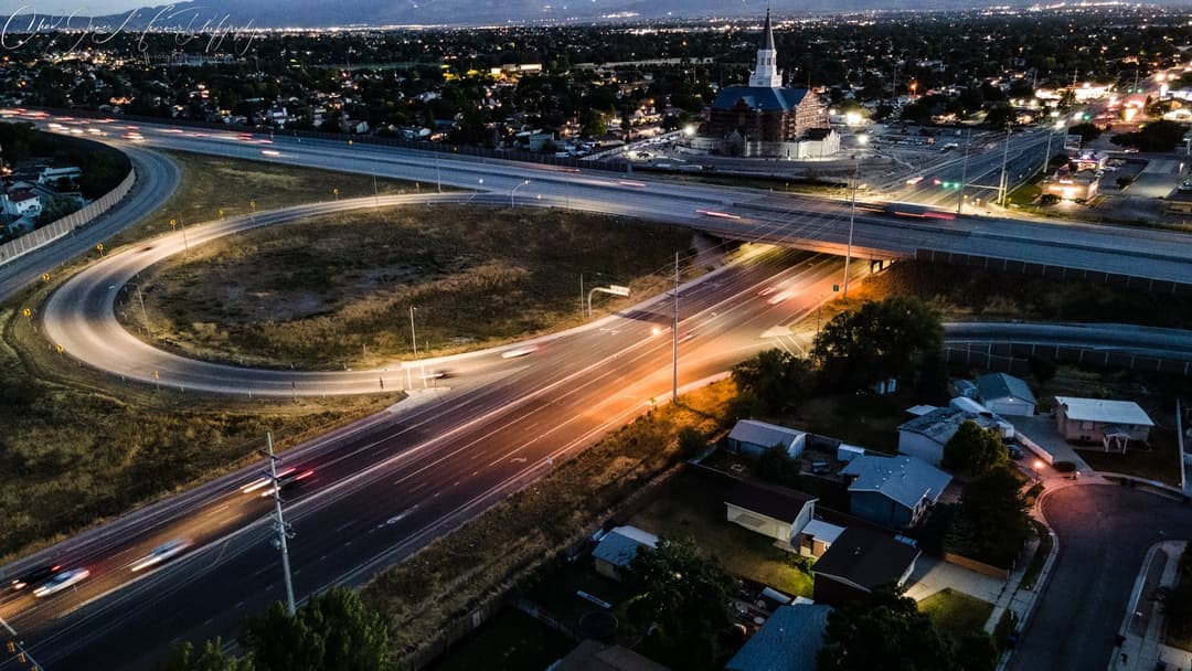 Aerial night view of the Taylorsville Utah Temple and highway interchange.