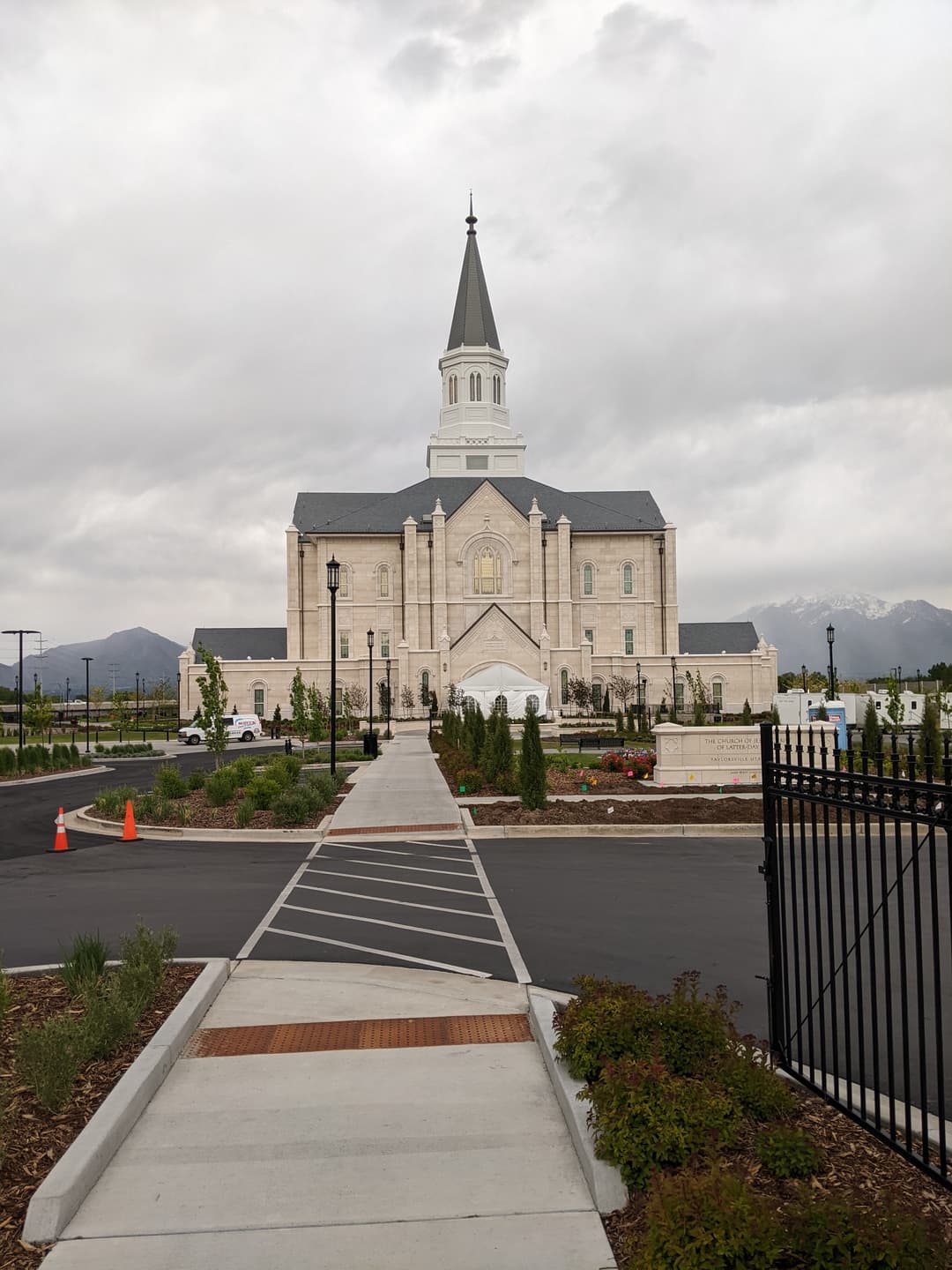 Front exterior view of the Taylorsville Utah Temple under overcast skies.