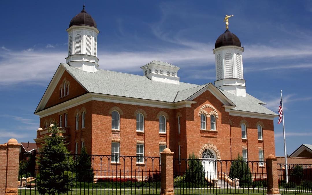 Daytime exterior view of the Vernal Utah Temple's red brick façade and towers.