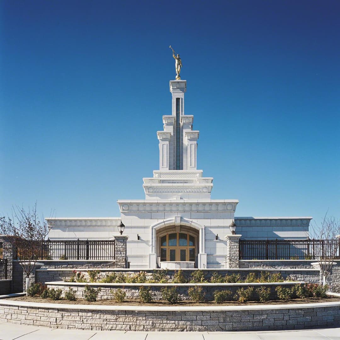 Symmetrical daytime view of the front entrance and single spire.