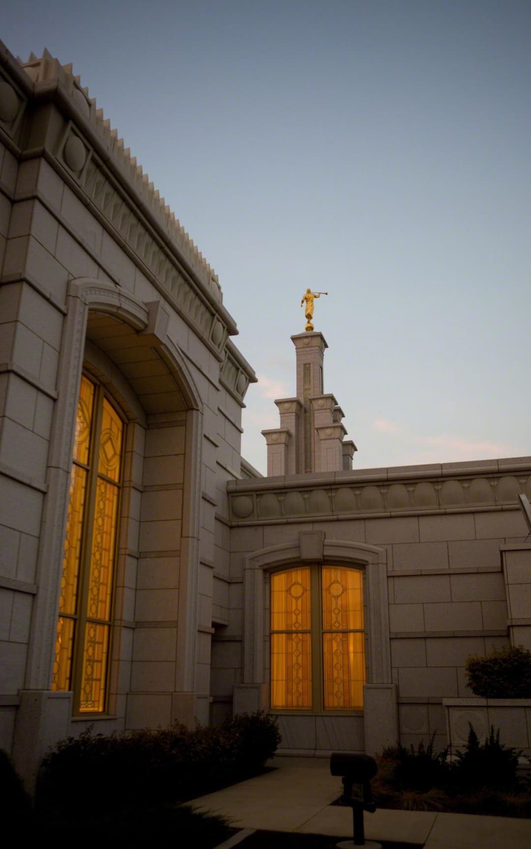 Columbia River Washington Temple spire and glowing windows at twilight.