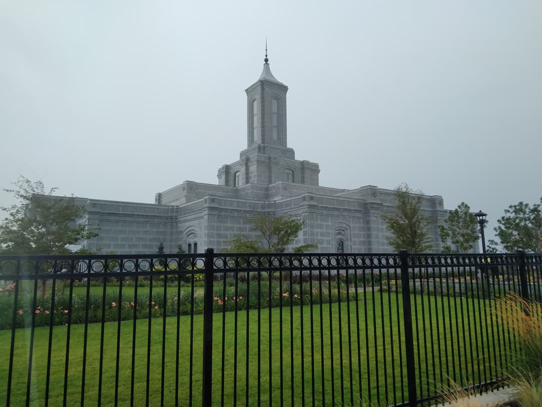 Moses Lake Washington Temple, tower and grounds, behind a fence, overcast.