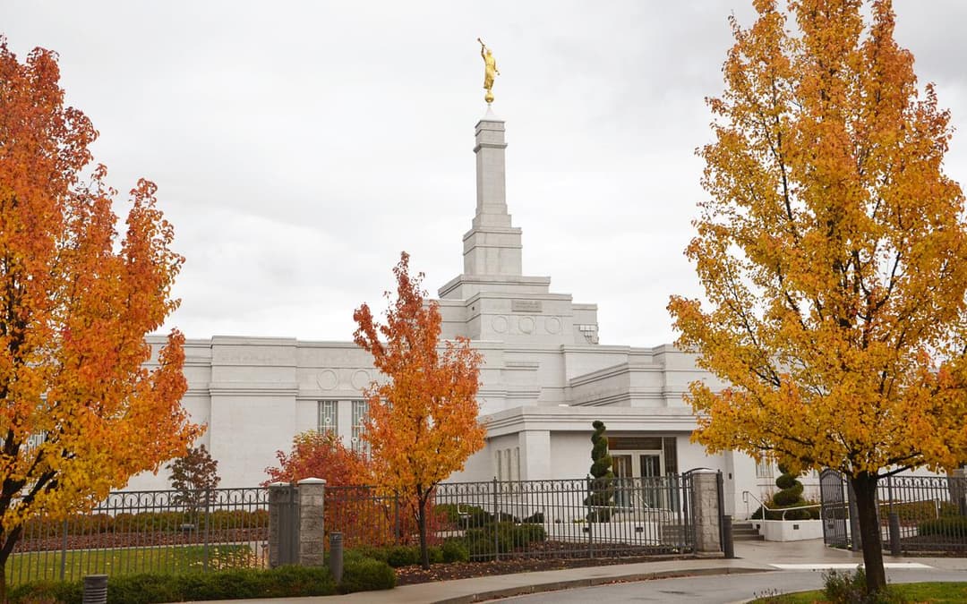 Exterior view of the Spokane Washington Temple framed by autumn trees.