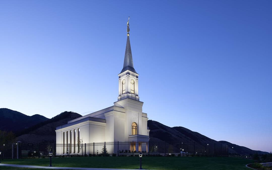 Star Valley Wyoming Temple exterior illuminated at twilight.