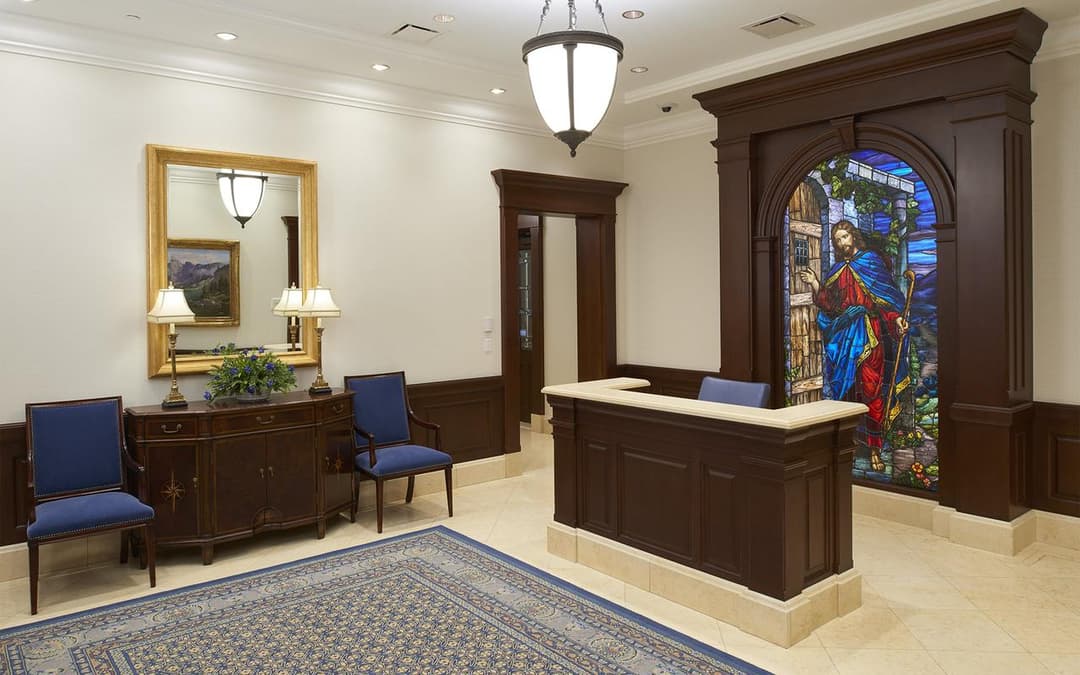Interior reception desk and lobby featuring stained-glass artwork.