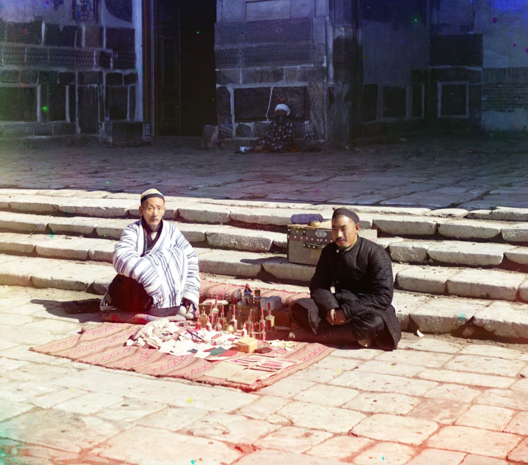 Vendors selling wares on stone steps at the Registan