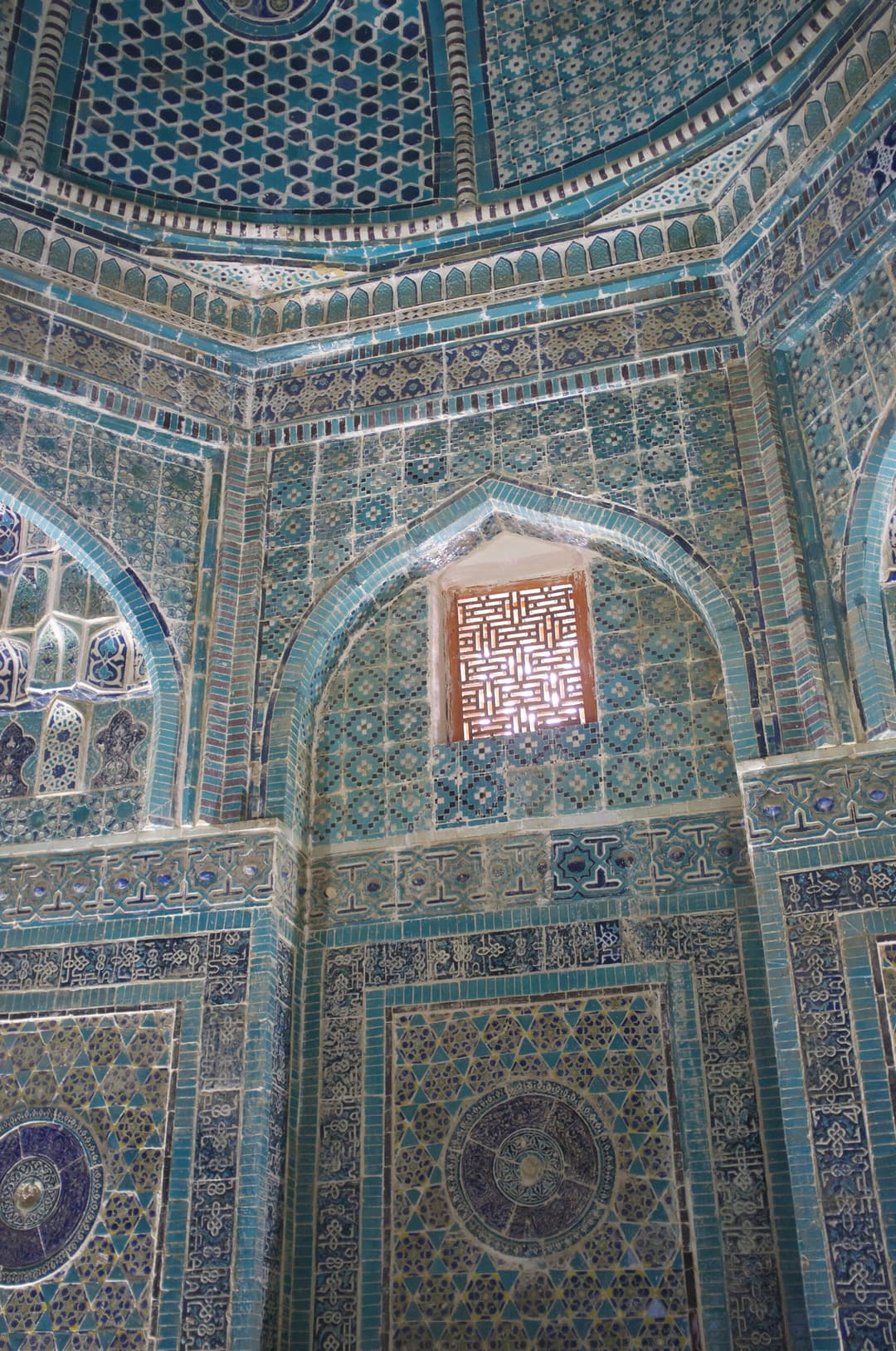 Interior view of intricate turquoise tilework in a Shah-i-Zinda mausoleum.