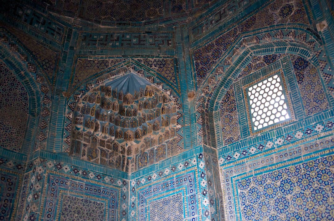 Interior view of tiled muqarnas squinch and window at Shah-i-Zinda.