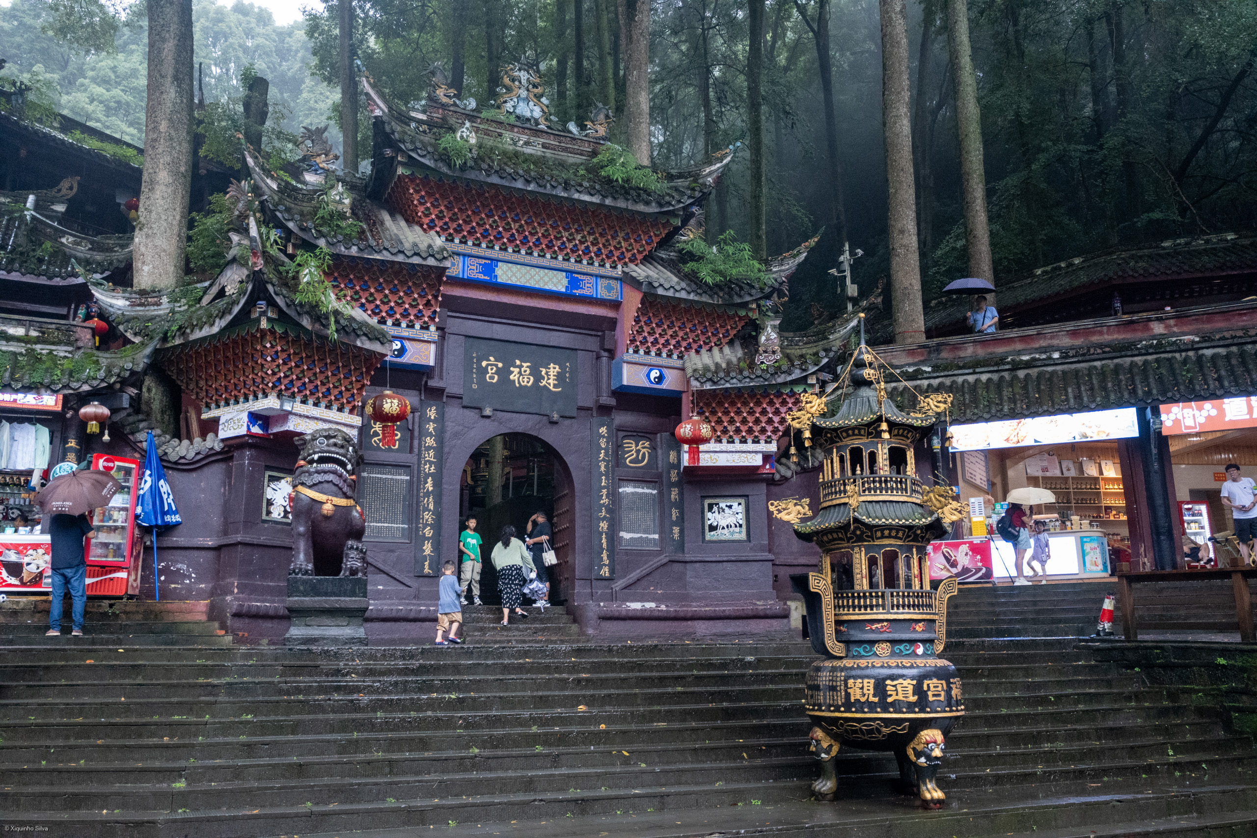 A Taoist temple nestled amidst the mountains, blending seamlessly with the natural landscape.