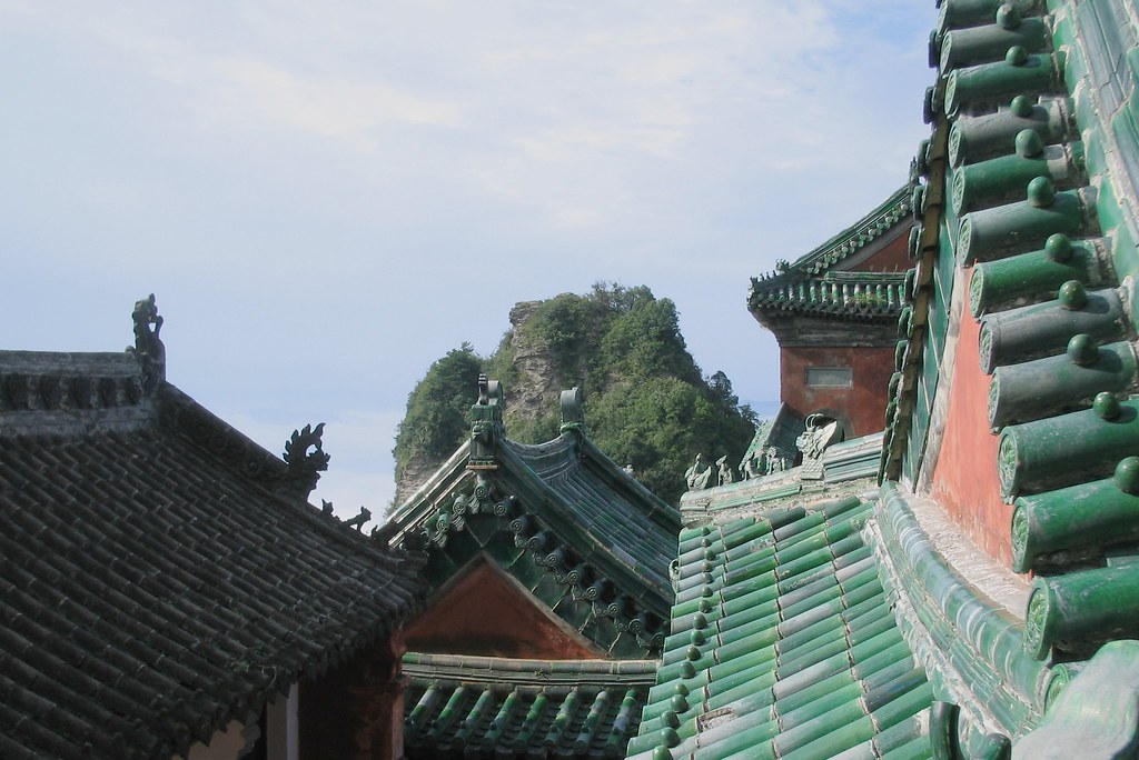 Traditional rooftops of Wudang Mountain temples, showcasing glazed ceramic tiles and curved eaves.