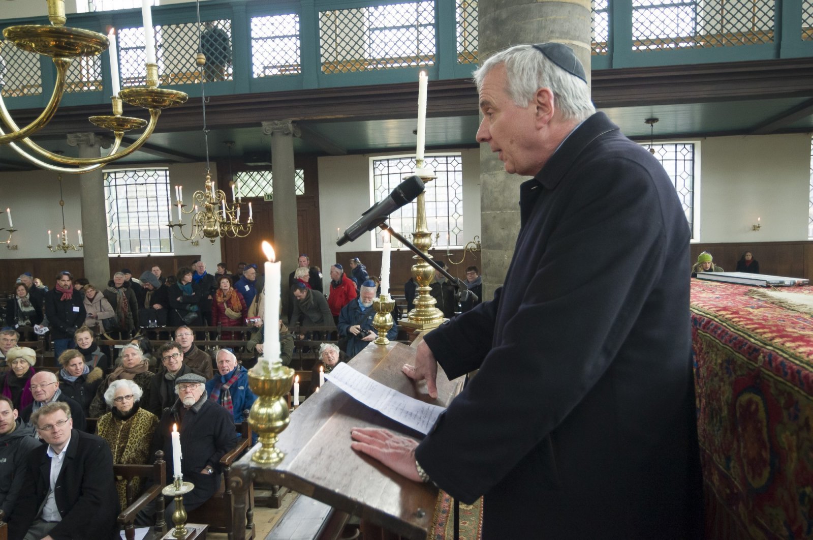 Interior of the Portuguese Synagogue, showcasing its grand architecture and candlelit atmosphere.