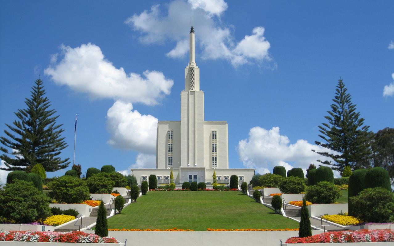 The Hamilton New Zealand Temple surrounded by lush greenery.