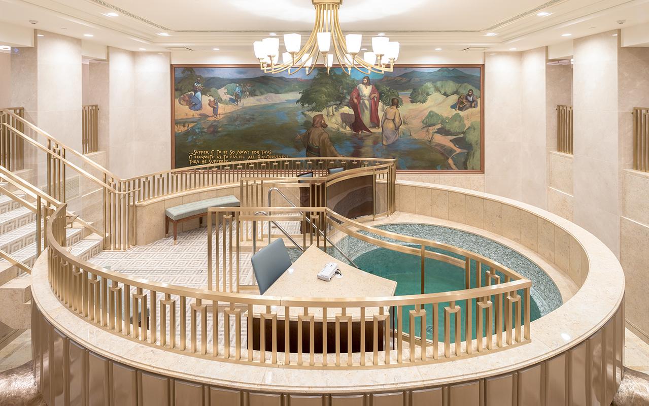 The Hamilton New Zealand Temple illuminated at night.