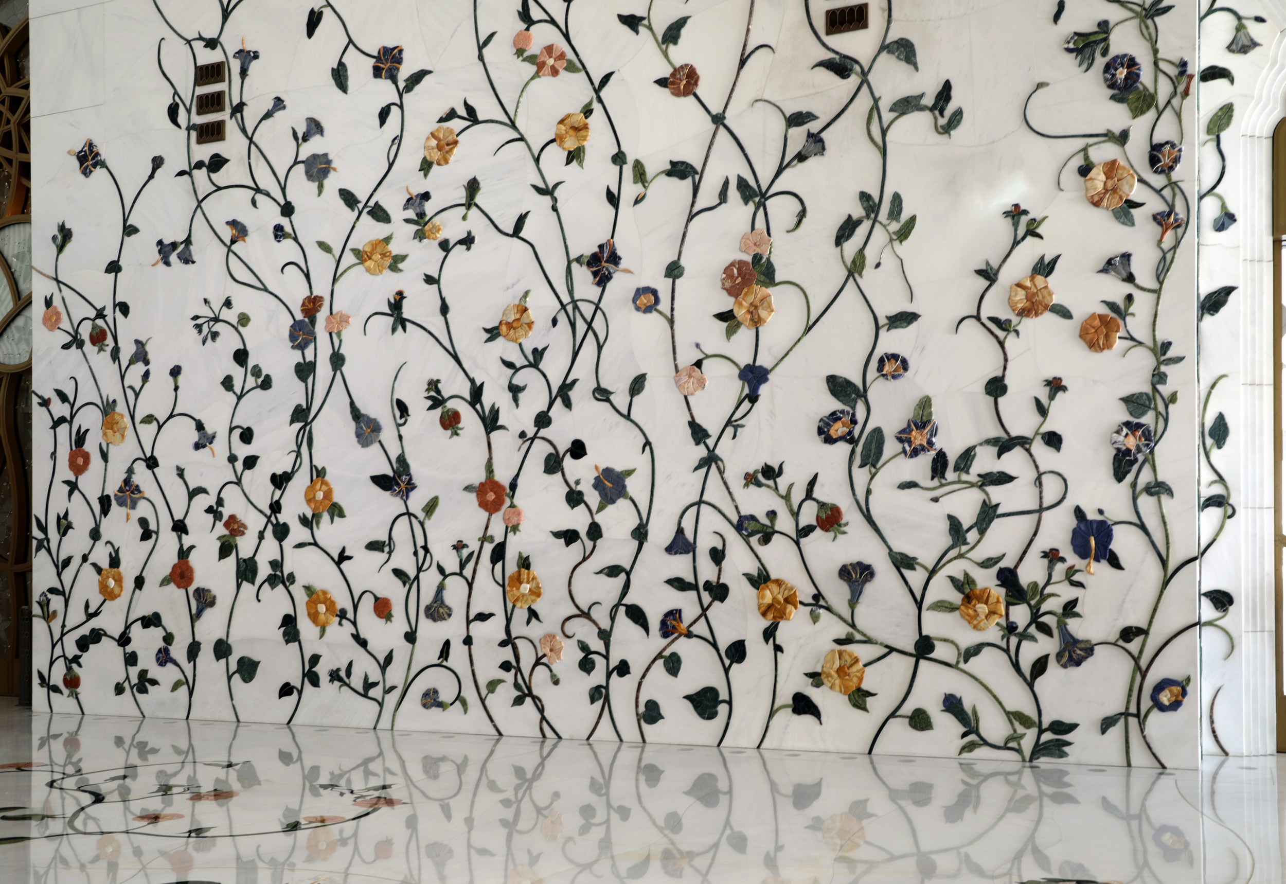 The mosque's exterior, clad in white marble, reflecting the sunlight.