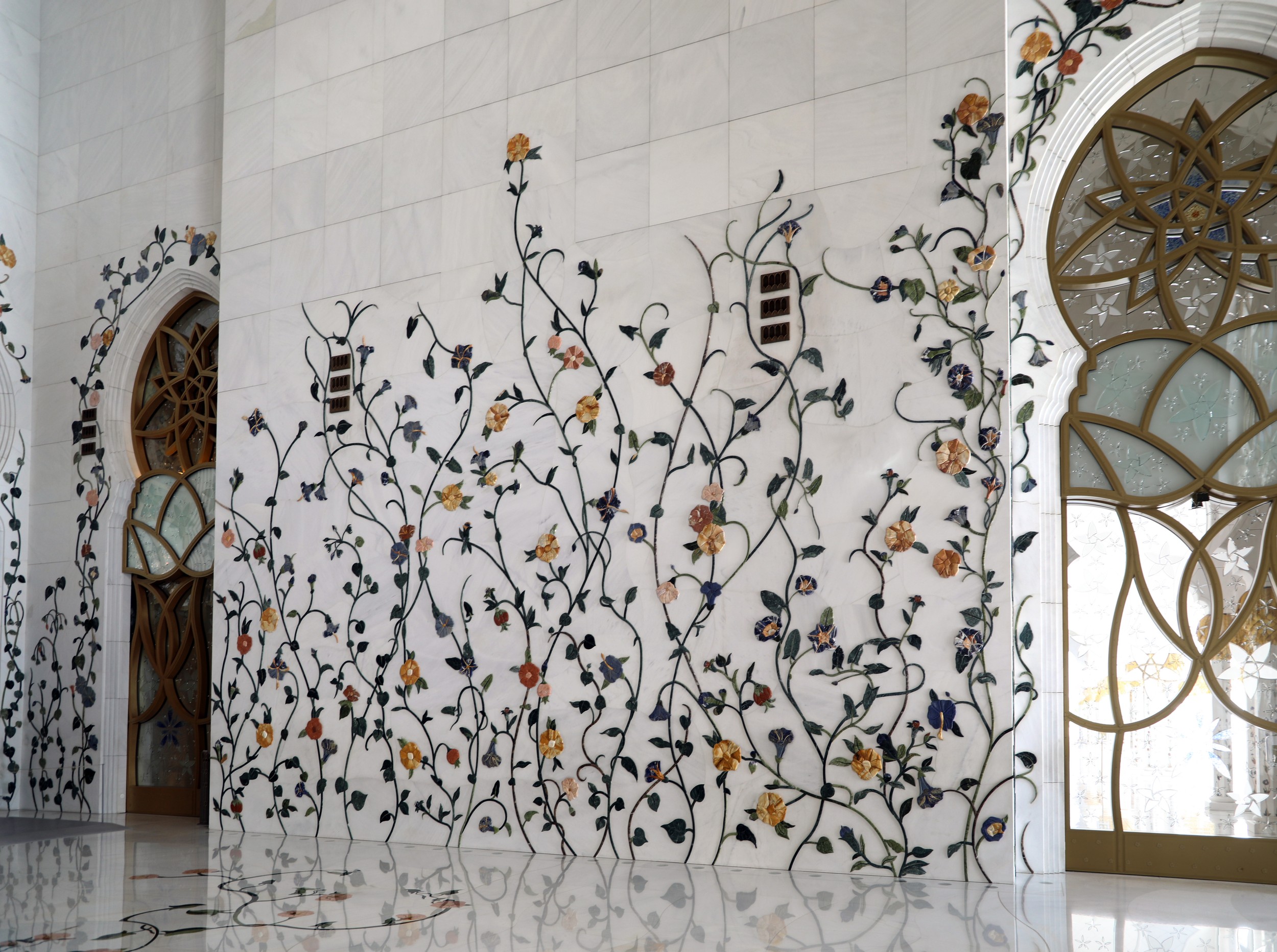 The mosque's minarets, each approximately 107 meters high, standing at the corners of the courtyard.