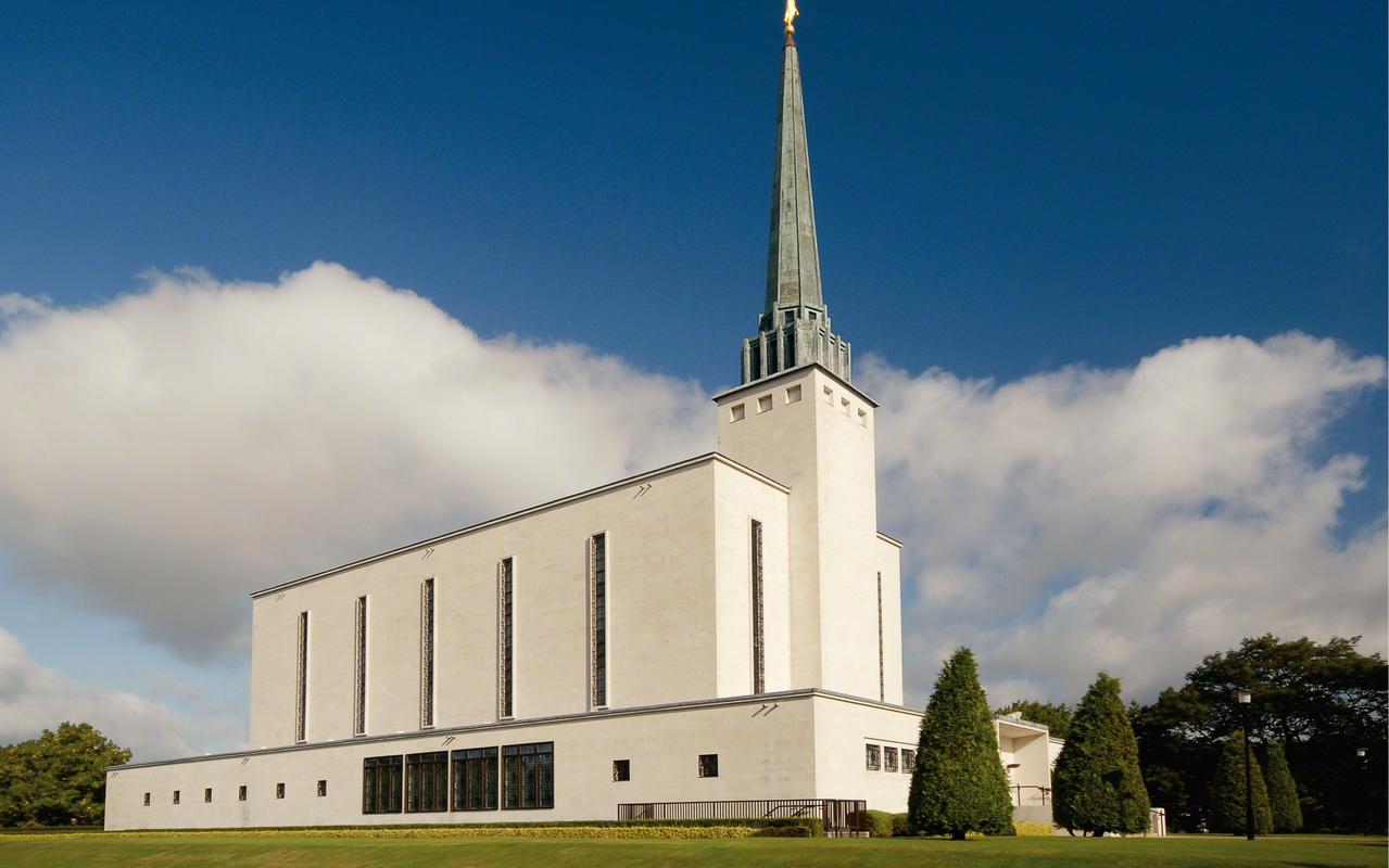The London England Temple at dusk, illuminated beautifully.