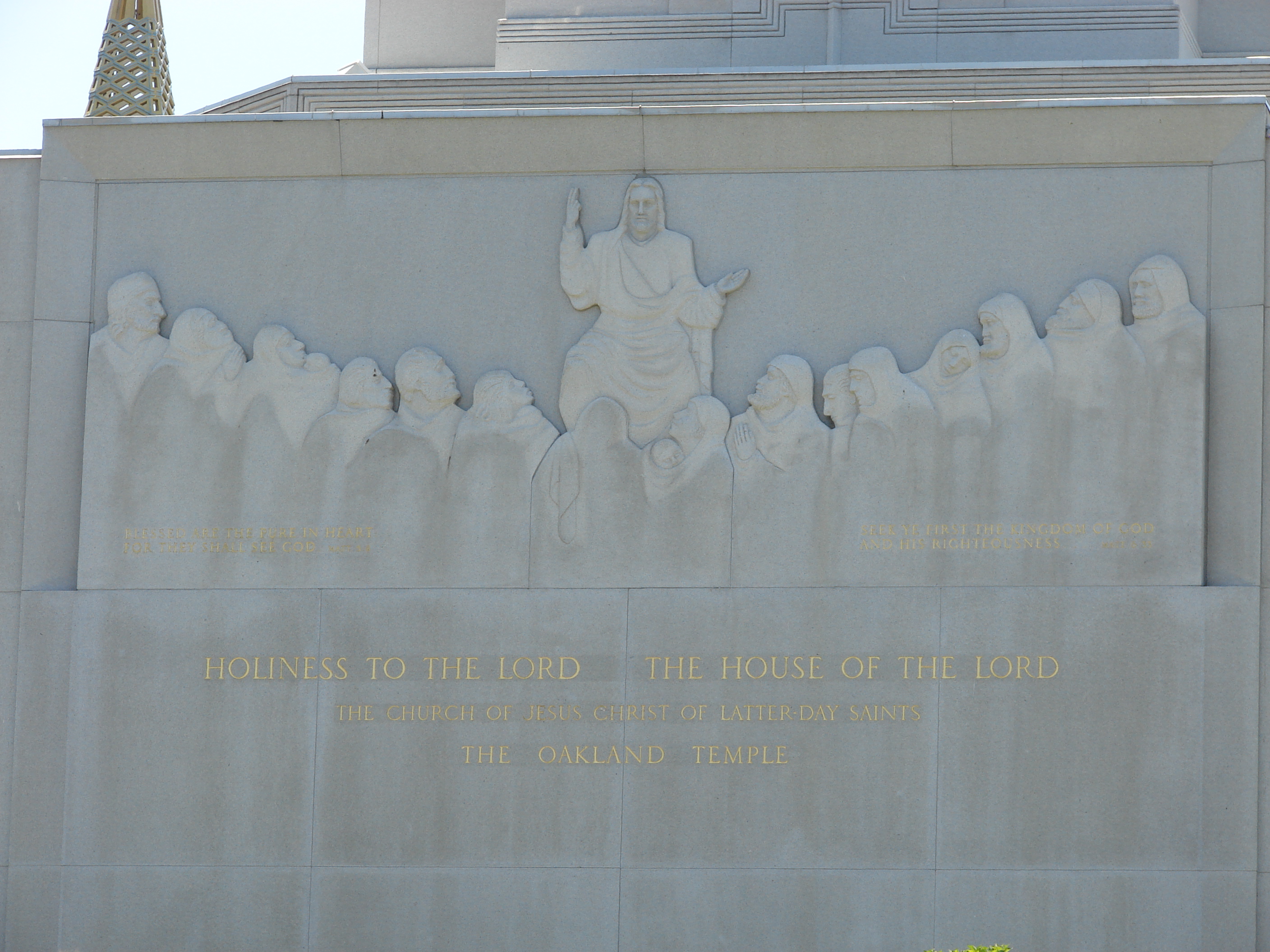 Detail of the temple exterior showing the intricate granite facing and landscaping.