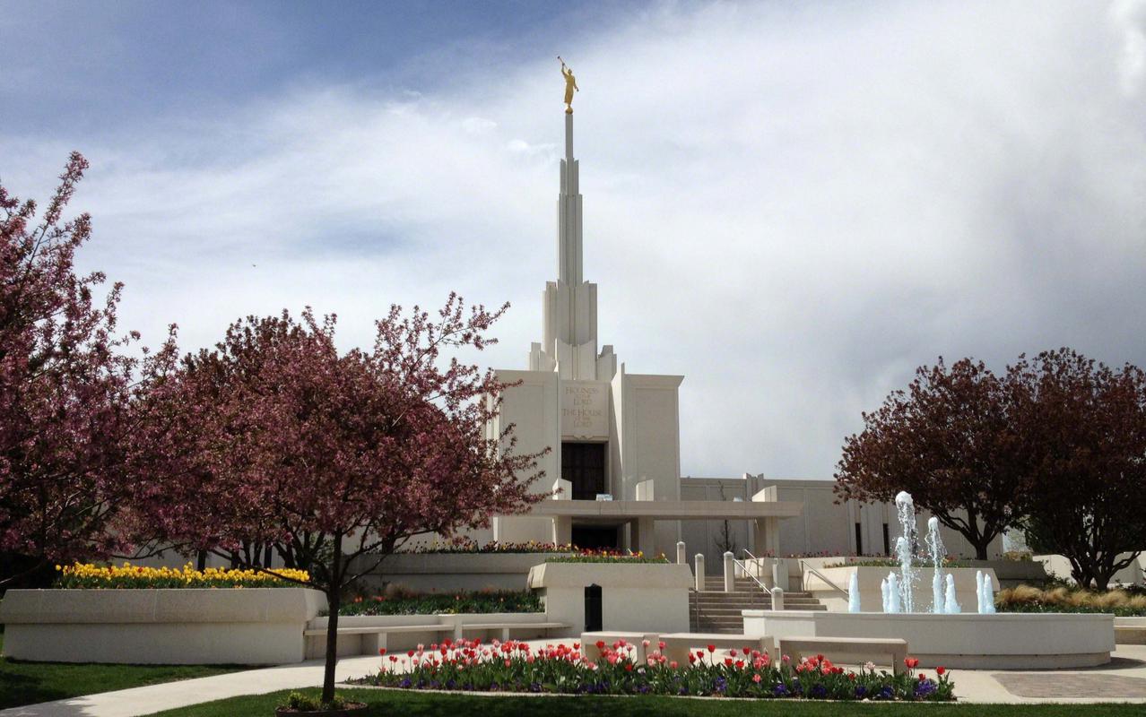 The water feature on the temple grounds, reflecting the building's silhouette.
