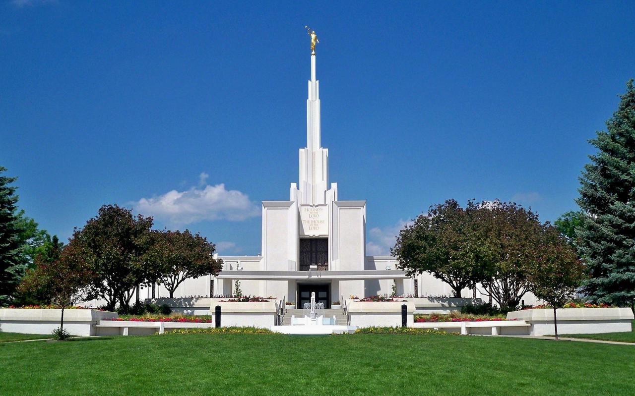 A panoramic view capturing the temple, its grounds, and the mountain backdrop.