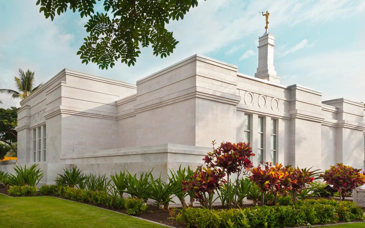 Exterior view of the Kona Hawaii Temple surrounded by lush greenery.